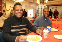 Derrick and Steve enjoy each other's company at a Christmas luncheon.
