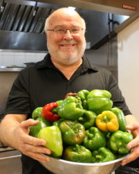 Executive Director Bob Emberger with the peppers he just harvested from our garden